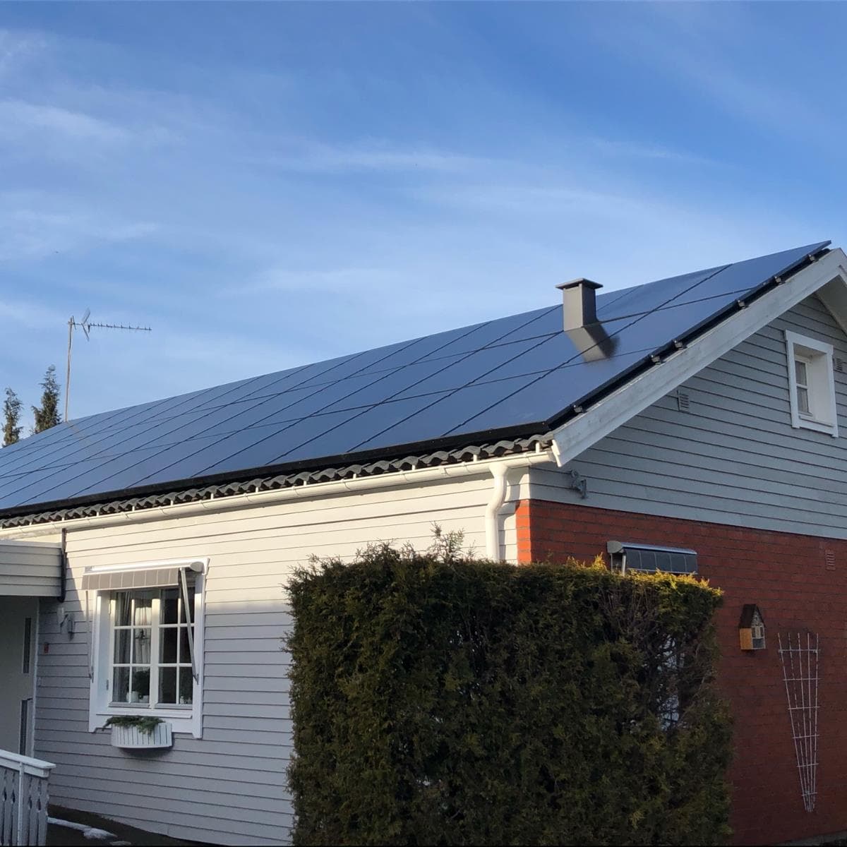 Villa i Värnamo med helsvarta solpaneler anpassade runt skorstenen